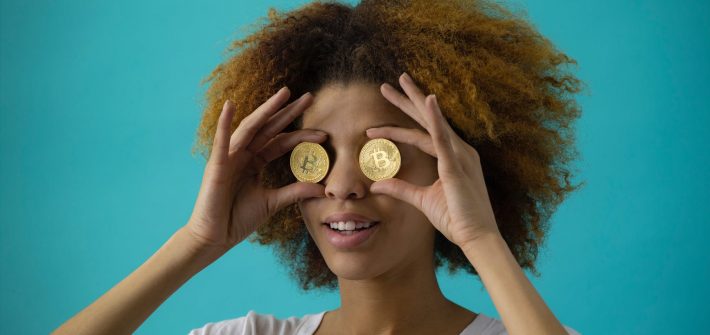 woman holding two coins